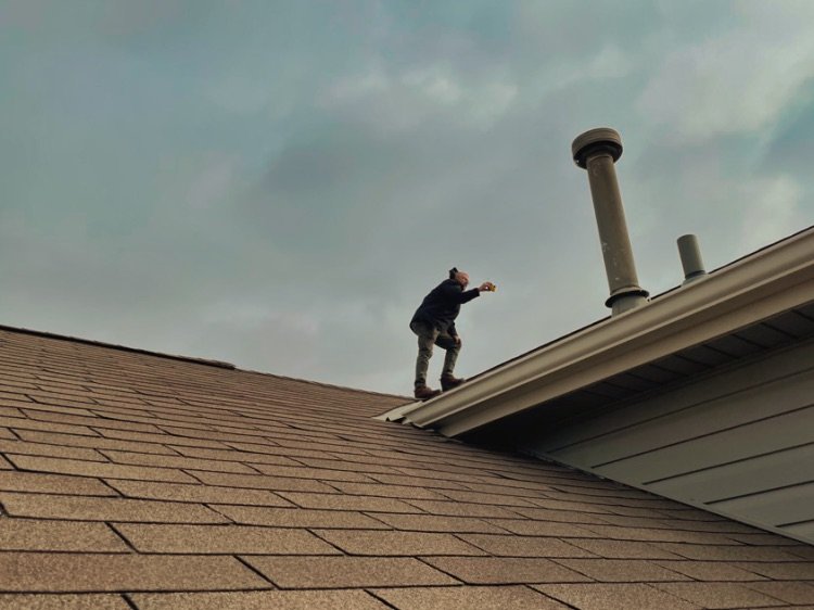 Home inspector looking at the roof of a home