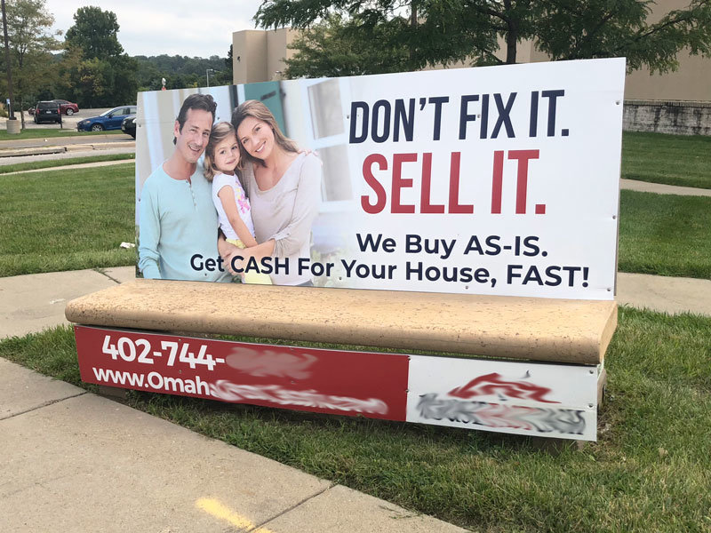 A bus bench advertisement depicts a smiling family and reads: Don't fit it. Sell it. We Buy AS-IS. Get CASH For Your House, FAST!